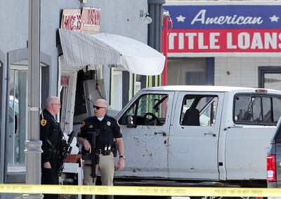 A white pickup truck that crashed into Princess Alterations, 3339 S. State, in South Salt Lake is pictured on Monday April 8, 2019. The driver of the pickup, who was suspected of committing two robberies and who apparently opened fire outside the Sheraton