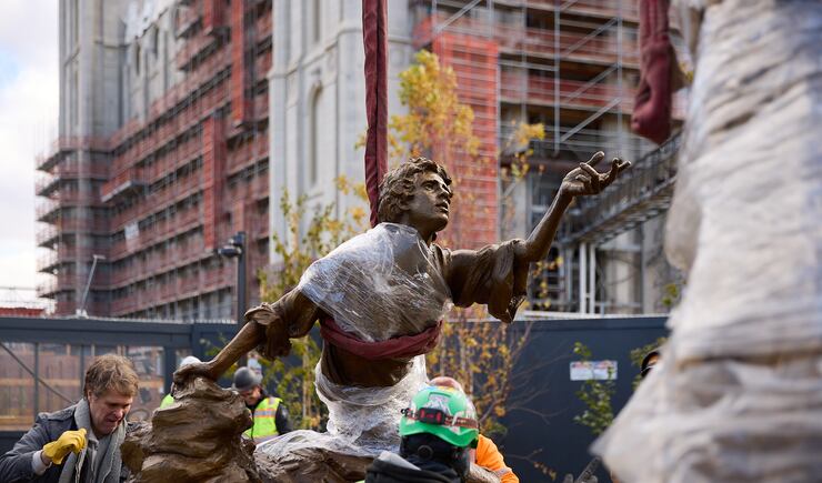 Sculptor Michael Hall helps place the First Vision statue on Temple Square on Wednesday, Nov. 6, 2024.