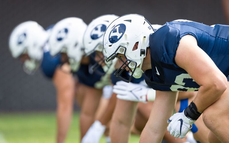 BYU players get in three-point stances Monday, Aug. 15, 2022, during fall camp in Provo