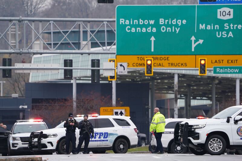 Law enforcement personnel block off the entrance to the Rainbow Bridge in Niagara Falls, N.Y.