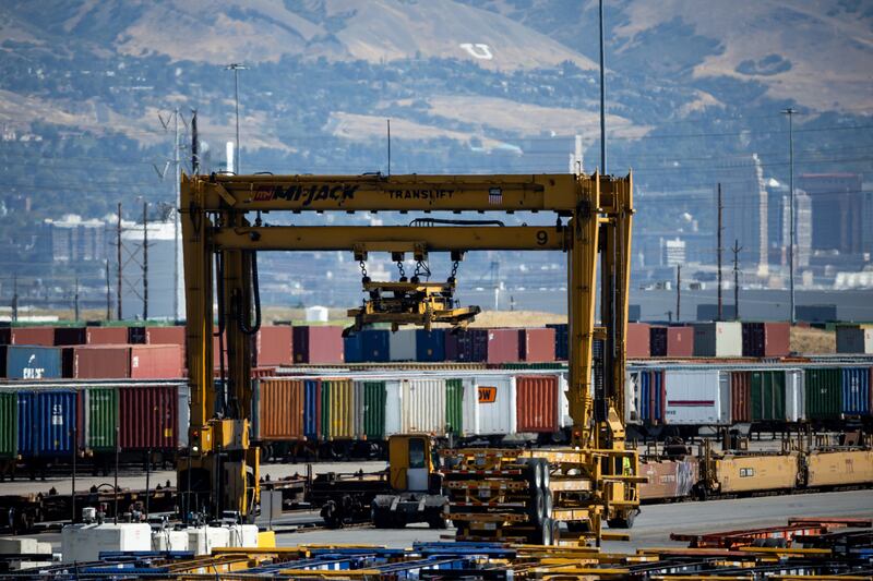 Shipping containers are moved between trains and trucks at the Union Pacific Intermodal Terminal.