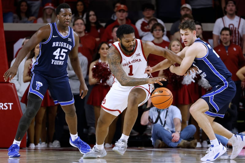 Oklahoma center John Hugley IV (1) and guard Trevin Knell, right, vie for the ball during a game against Oklahoma Tuesday, Feb. 6, 2024, in Norman, Okla.