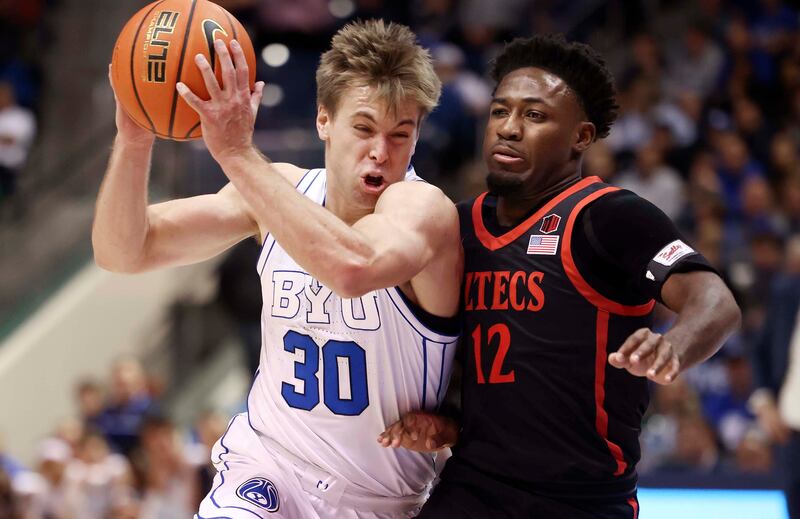 BYU Cougars guard Dallin Hall (30) drives into San Diego State Aztecs guard Darrion Trammell (12) at the Marriott Center on Nov. 10, 2023.