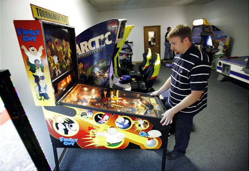 Ryan Miller, of Ottumwa, Iowa, plays a pinball game at a local video arcade in Ottumwa, Iowa. Ottumwa city officials announced in April plans to develop what they're calling the International Video Game Hall of Fame.