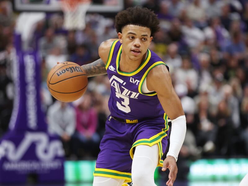 Utah Jazz guard Keyonte George (wearing purple) dribbles up court.