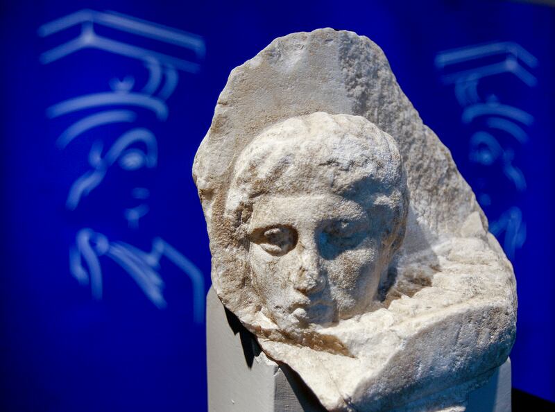 The marble head of a young man is displayed during a presentation to the press at the new Acropolis Museum in Athens.