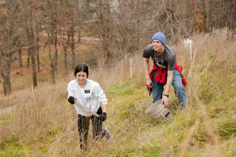 Missionaries from the New York Syracuse Mission plant tree nuts and seeds as part of the reforestation of the Hill Cumorah.