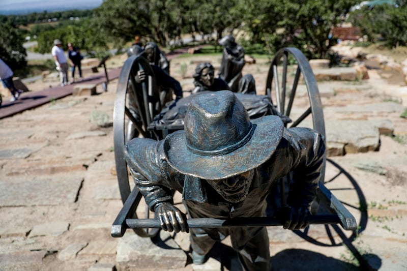 A sculpture depicts a handcart team at the Children’s Pioneer Memorial at This Is the Place Heritage Park.