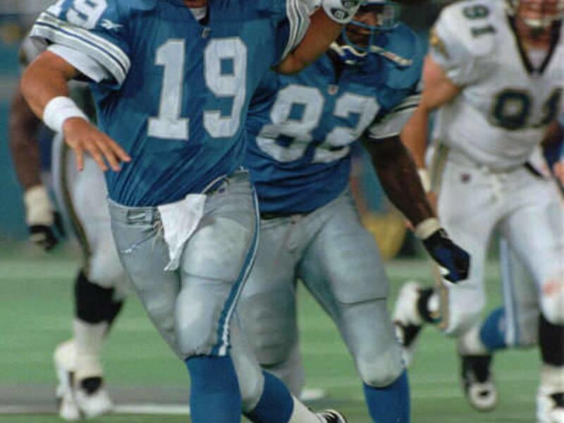 Detroit Lions quarterback Scott Mitchell (19) scrambles to pass as Detroit's Rodney Holman (82) blocks in the second quarter Thursday, Aug. 10, 1995, in Pontiac, Mich. Mitchell passed for 128 yards and one touchdown in the Lions' 19-3 exhibition win over