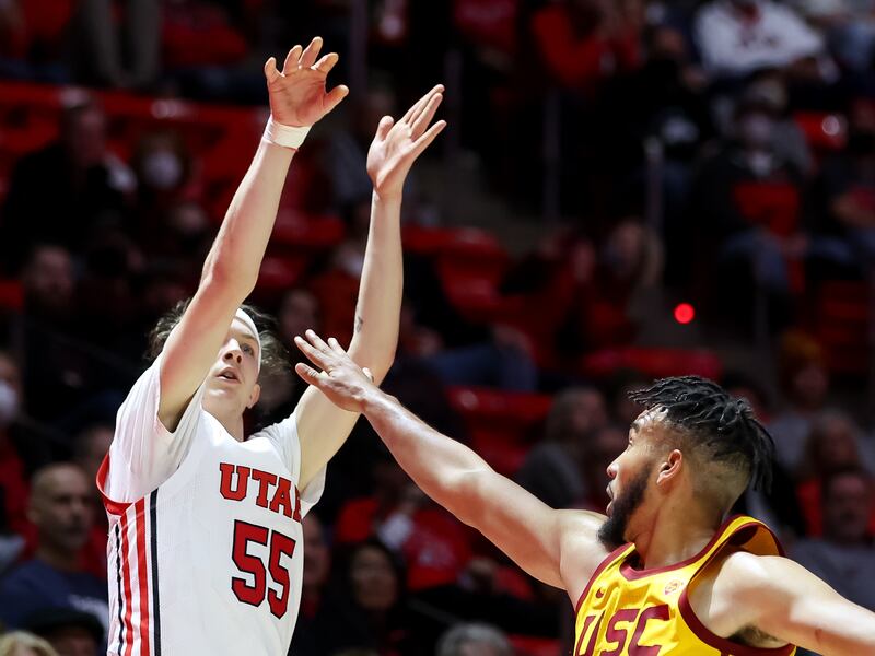 Utah Utes guard Gabe Madsen sinks a 3-pointer over USC Trojans forward Isaiah Mobley.