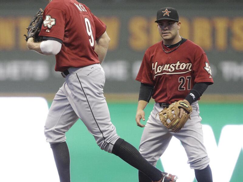 Houston Astros' Jose Altuve (27) watches as teammate Hunter Pence is taken out of the game during the fifth inning of a baseball game against the Milwaukee Brewers Friday, July 29, 2011, in Milwaukee. Pence has been pulled from the game amid reports he's
