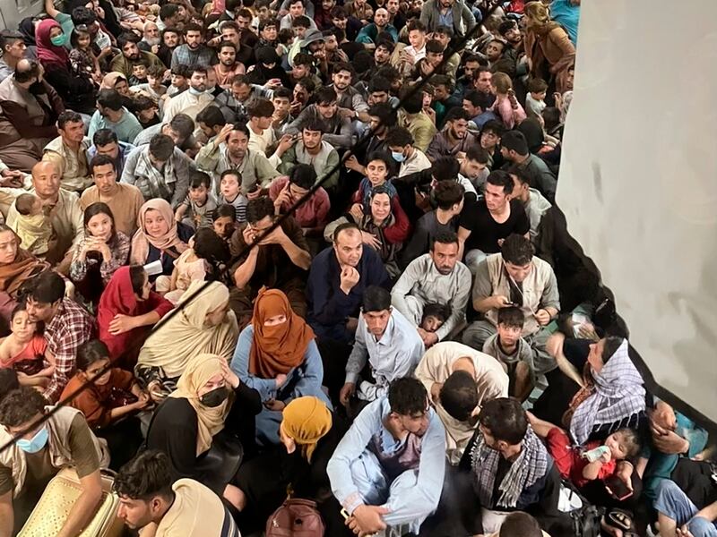 Afghan citizens pack inside a U.S. Air Force plane as they are transported from Hamid Karzai International Airport in Afghanistan.