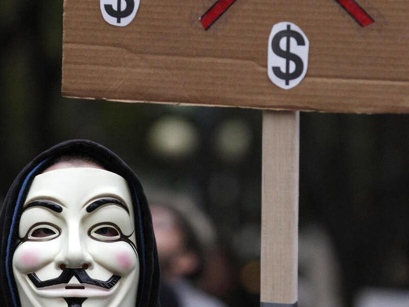 In this photo taken Wednesday, Nov. 2, 2011, an Occupy Seattle protester wears a Guy Fawkes mask while protesting in downtown Seattle. From New York to San Francisco to London, some of the demonstrators decrying a variety of society's ills are sporting th