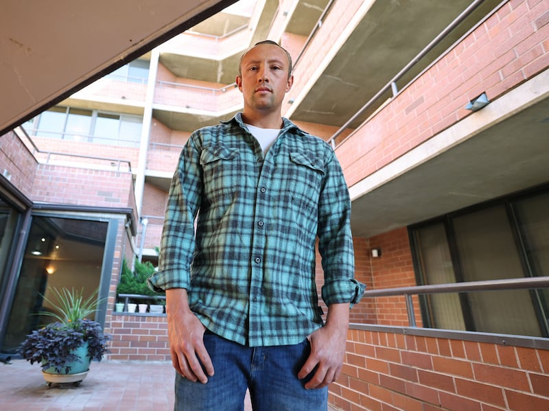 Matthew Hinojos stands at Arlington Place condominiums where he lives in Salt Lake City on Tuesday, Oct. 4, 2022.