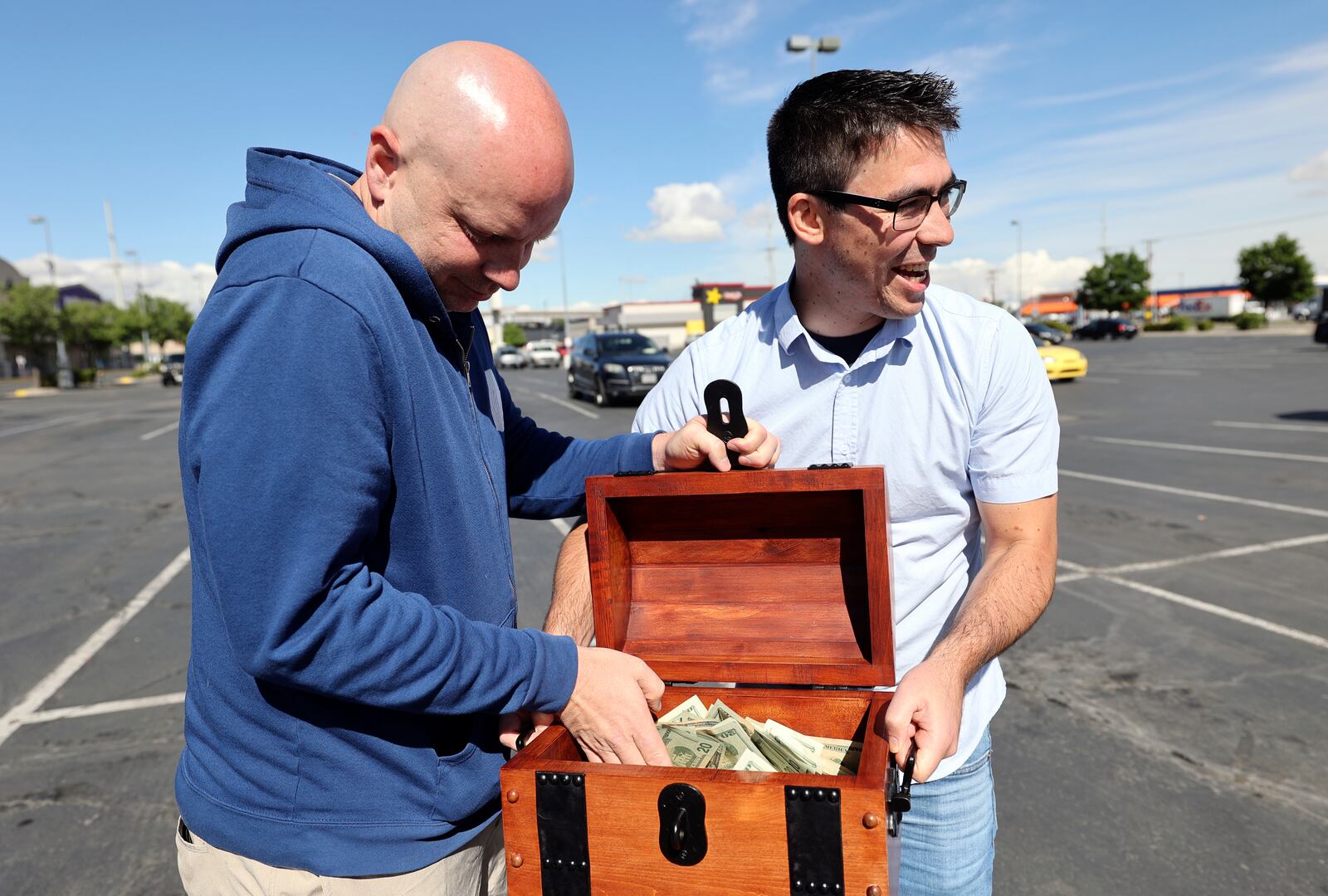 John Maxim, left, and David Cline announce plans to hide $20,000 in the Utah wilderness during a press conference on Tuesday.