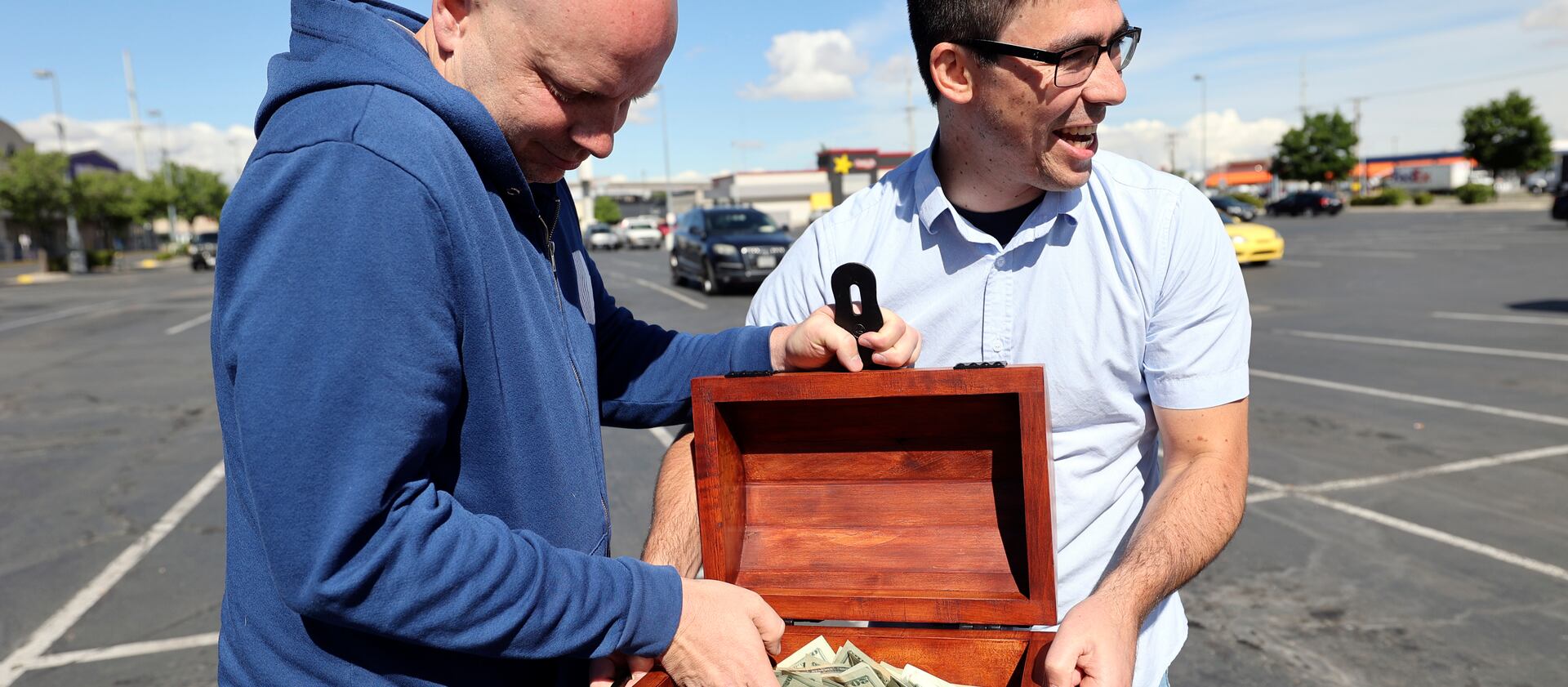 John Maxim, left, and David Cline announce plans to hide $20,000 in the Utah wilderness during a press conference on Tuesday.