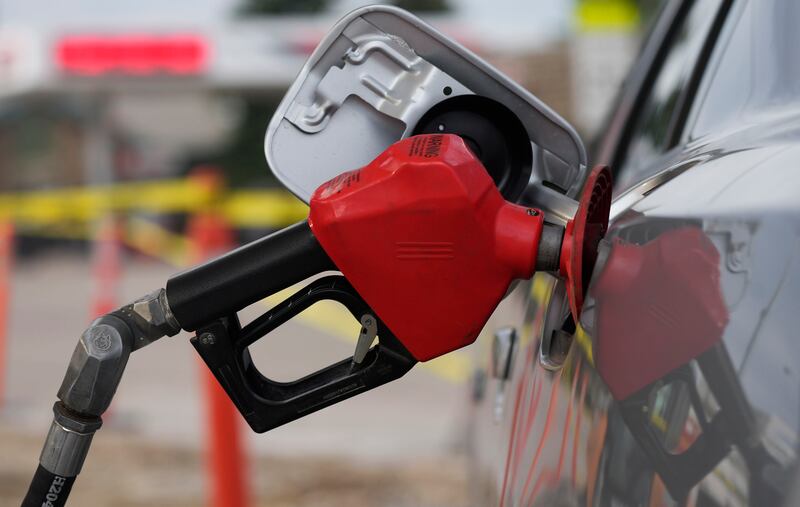 A motorist is pictured filling his car with gas.