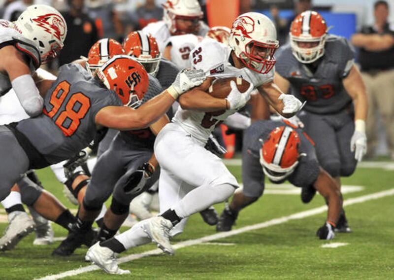 Southern Utah's James Felila (23) breaks the grip of Idaho State's Drew Sharkey (98) on his way to a touchdown in the second quarter of an NCAA college football game, Saturday, Oct. 29, 2016 at Holt Arena in Pocatello, Idaho.
