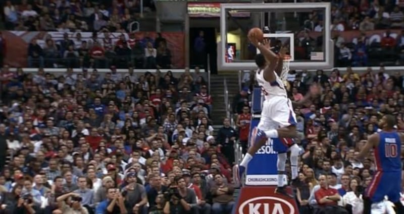DeAndre Jordan slams the ball over Brandon Knight in NBA action