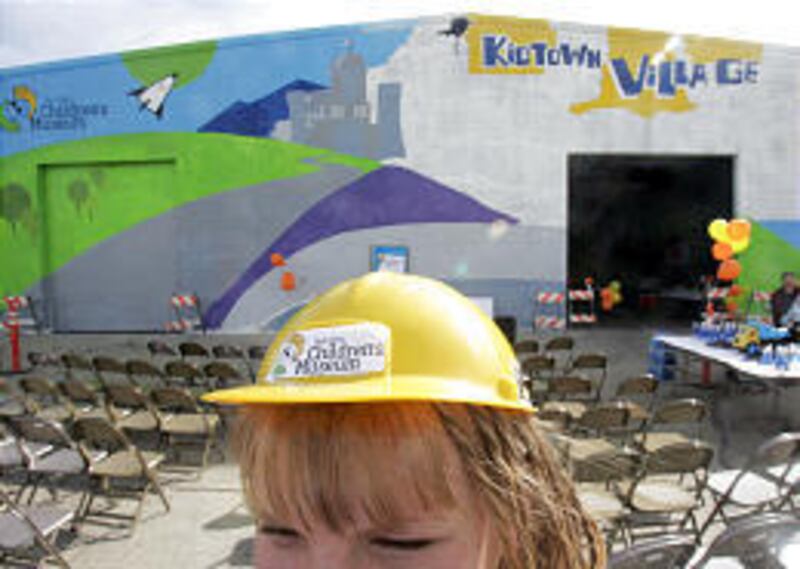 Tanya Rouse wears a hard hat sporting the name of the new Utah Valley Children's Museum following an announcement about the museum on Friday in Orem.
