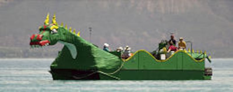 A large pontoon boat that is in the shape of a sea monster and run by Brian Hirschi ferries tourists on a tour of Bear Lake, north of Garden City.
