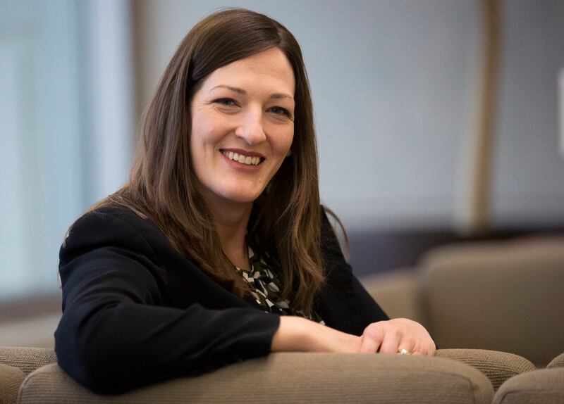 Sharalyn Howcroft, who has worked for the Church History Library since 2000, and experienced the births of two sets of twins, the first set without any paid leave and the second set with paid leave, poses for photos at the library on Friday, Jan. 19, 2018