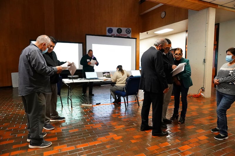 People look at early voting results in Brownsville, Texas