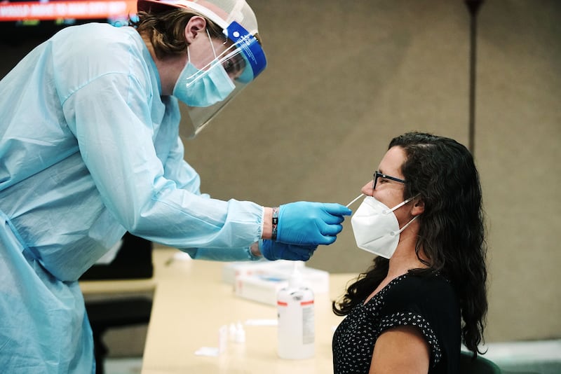 Ryan Jensen gives Utah Valley University instructor Lauren Brooks a COVID-19 test.
