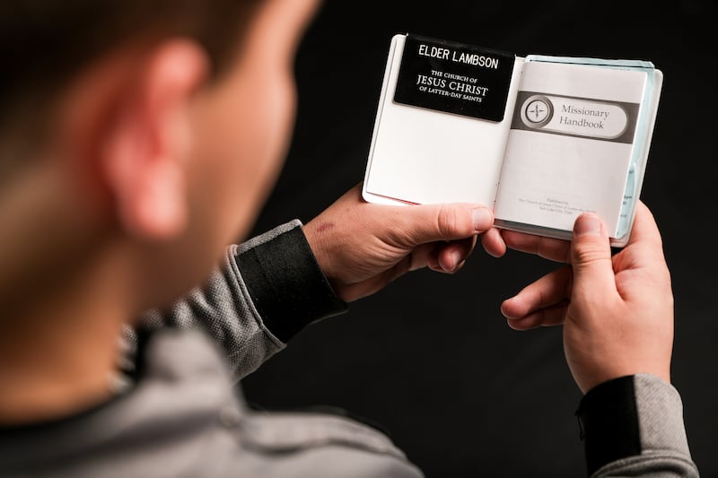 James Lambson, 20, holds his Missionary Handbook while posing for a photo at the Deseret News in Salt Lake City on Tuesday, Oct. 9, 2018.