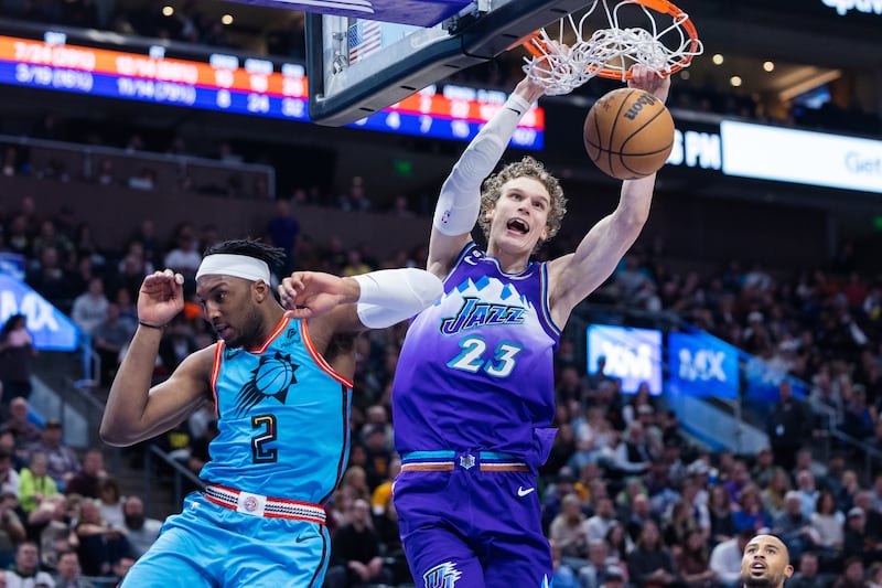 Utah Jazz forward Lauri Markkanen dunks the ball over Phoenix Suns forward Josh Okogie.