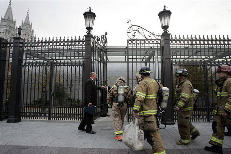 Firefighters enter Temple Square in Salt Lake Thursday. Two temples and a Catholic fraternity received envelopes containing powder.