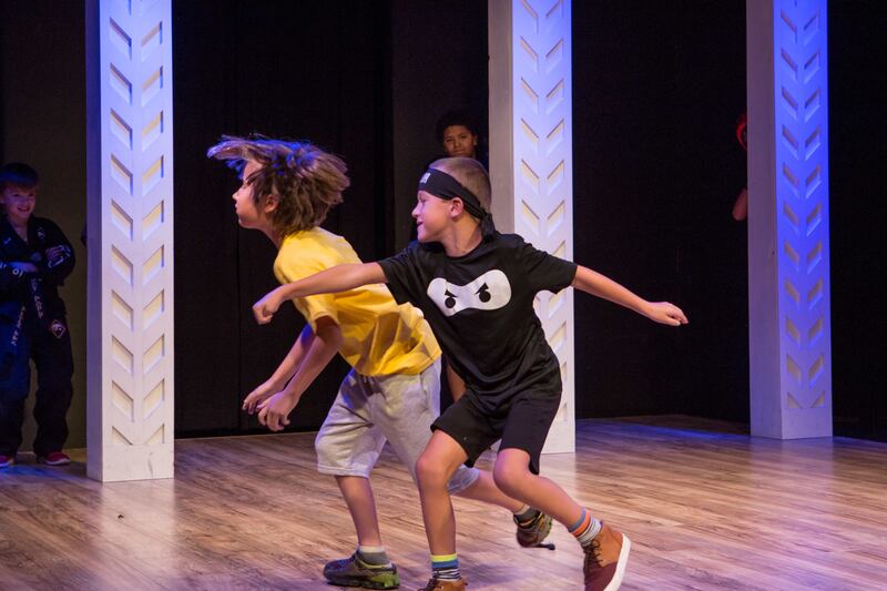 Two campers rehearse onstage at a Utah Children's Theatre summer camp.