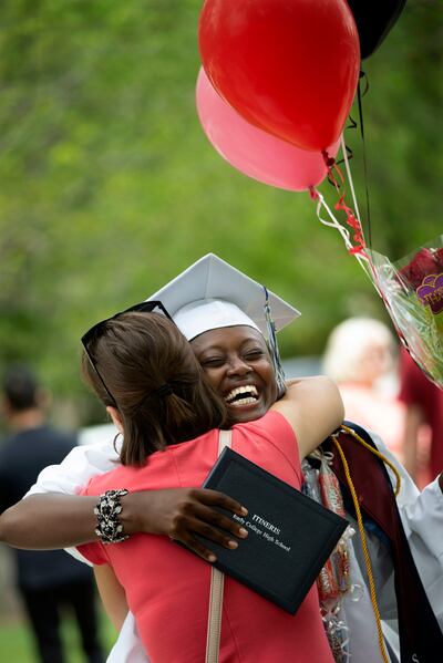 Desange Kuenihira hugs her foster mother, Arianne Wortham, after graduating from Itineris Early College High School at Thanksgiving Point in Lehi on Wednesday, May 15, 2019. When Kuenihira was a young girl growing up in a refugee camp without parents, she