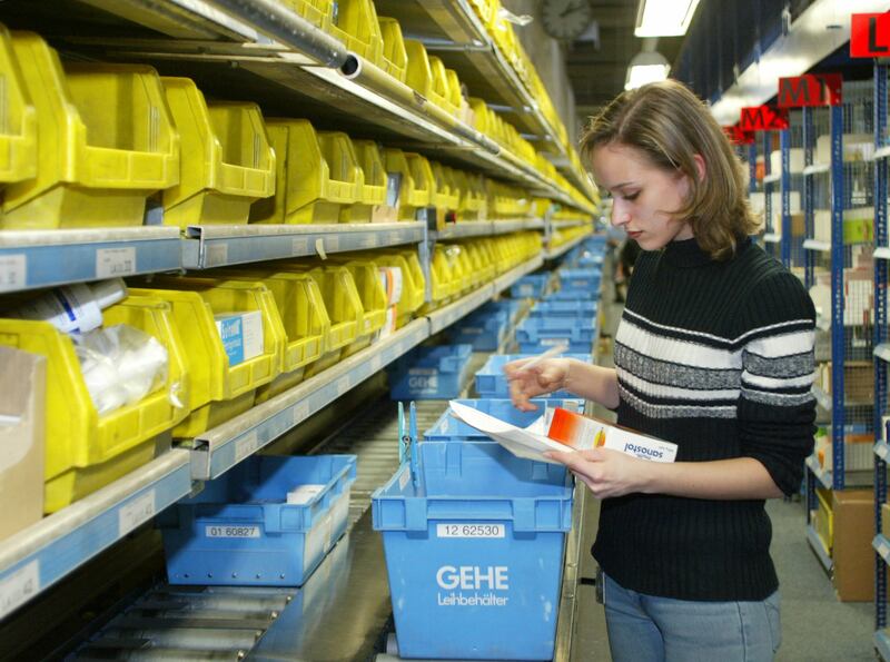 Chrisula Gaitatzi fills a box with pharma products at the GEHE AG in Stuttgart, southwestern Germany, on Wednesday, March 12, 2003.