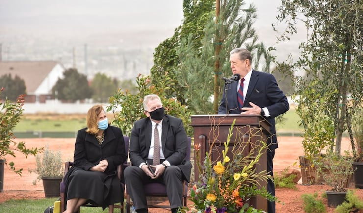 Elder Jeffrey R. Holland, Quorum of the Twelve Apostles of The Church of Jesus Christ of Latter-day Saints, speaks at the groundbreaking service for the Red Cliffs Utah Temple in St. George, Utah, Saturday, Nov. 7, 2020. Seated behind Holland are, from left, Sister Debbie Christensen, and Elder Craig C. Christensen, Utah Area President.