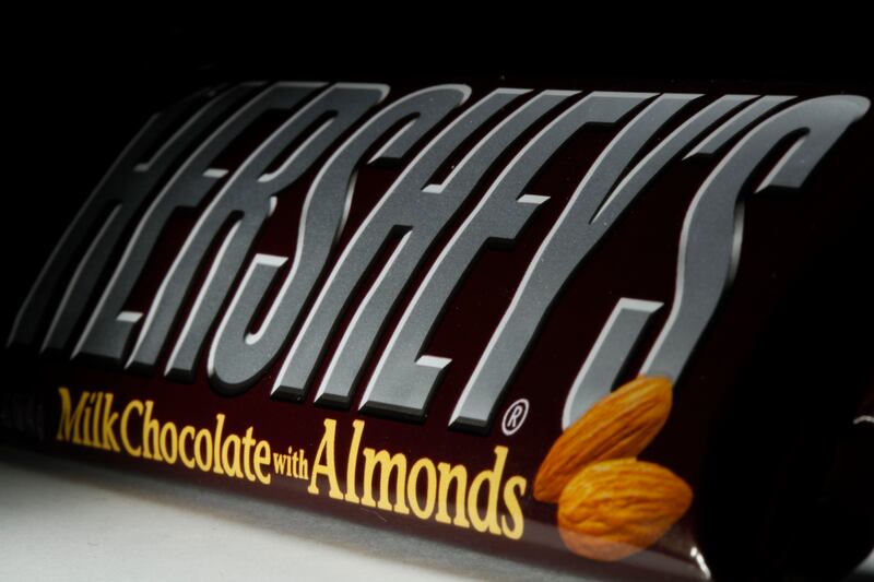 This April 21, 2020 file photo shows a Hershey’s chocolate bar with almonds in Philadelphia. Hershey says its Halloween candy sales were up slightly this year despite lower enthusiasm for trick-or-treating amid the pandemic.