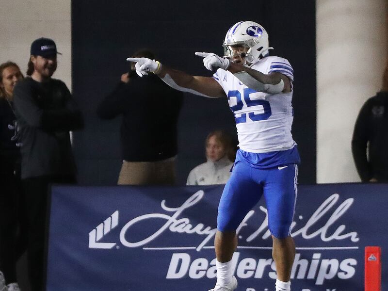 BYU running back Tyler Allgeier celebrates after a big play against Utah State \in Logan on Friday, Oct. 1, 2021.