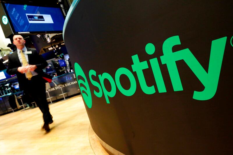 A trading post sports the Spotify logo on the floor of the New York Stock Exchange.