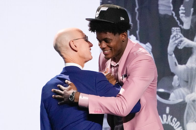 Taylor Hendricks hugs NBA Commissioner Adam Silver after being selected ninth overall by the Utah Jazz During the NBA basketball draft, Thursday, June 22, 2023, in New York