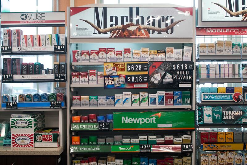 FILE - In this May 18, 2017 file photo, packs of cigarettes are offered for sale at a convenience store in Helena, Mont.