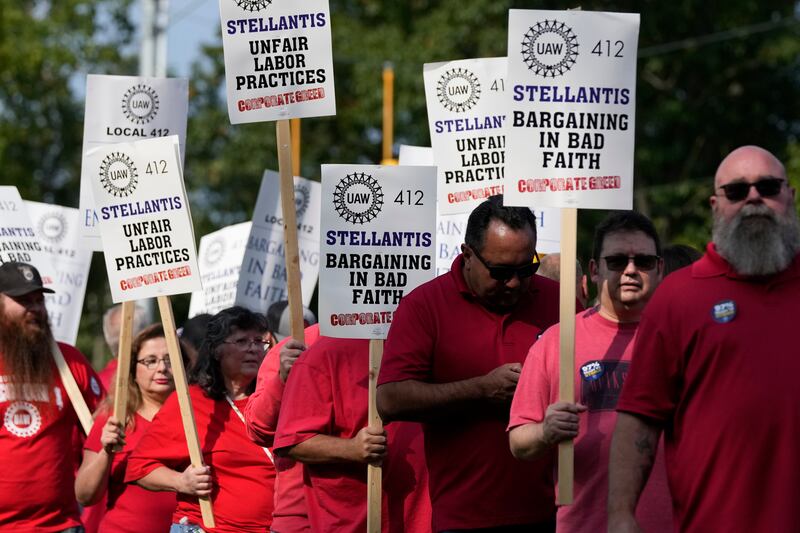 United Auto Workers march outside the Stellantis North American Headquarters in Auburn Hills, Mich.