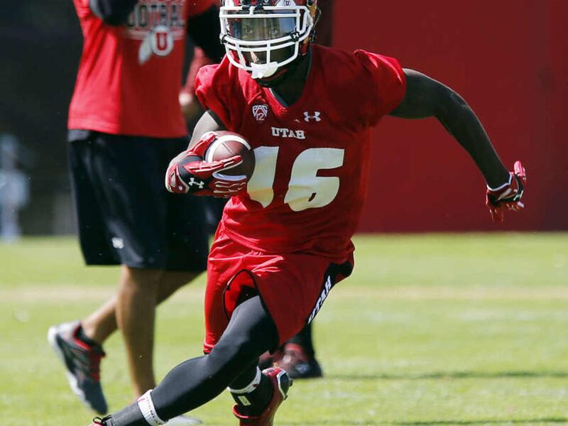 Cory Butler runs the ball during University of Utah football practice in Salt Lake City, Thursday, Aug. 6, 2015.