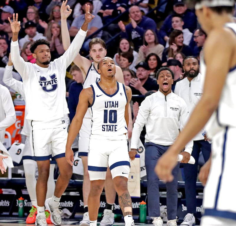 Utah State guard Darius Brown II (10) leads the celebration following a key play during the Aggies' win over Boise State on Feb. 10, at the Spectrum in Logan.