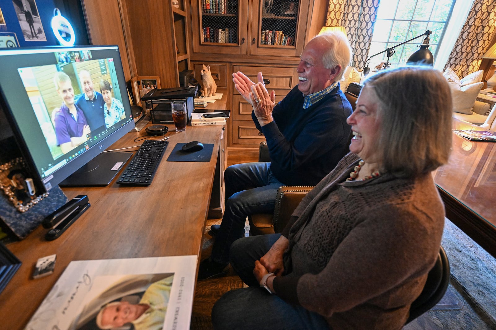 Dell Loy Hansen sits with his cousin Lucinda Wiser, who is visiting at his home in Holladay, as they watch a home gifting live on Zoom in Ukraine on Sept. 28, 2023.