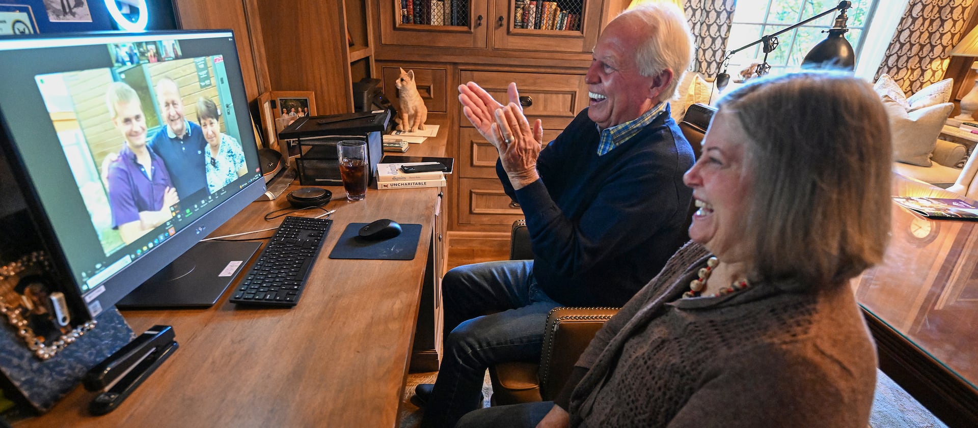 Dell Loy Hansen sits with his cousin Lucinda Wiser, who is visiting at his home in Holladay, as they watch a home gifting live on Zoom in Ukraine on Sept. 28, 2023.