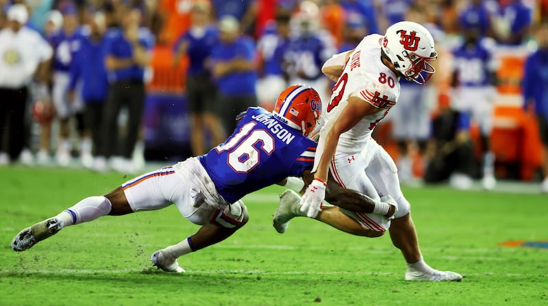 Utah Utes tight end Brant Kuithe (80) is tackled by Florida Gators safety Tre’Vez Johnson (16) as Utah and Florida play in Gainesvillle, Fla., on Saturday, Sept. 3, 2022.