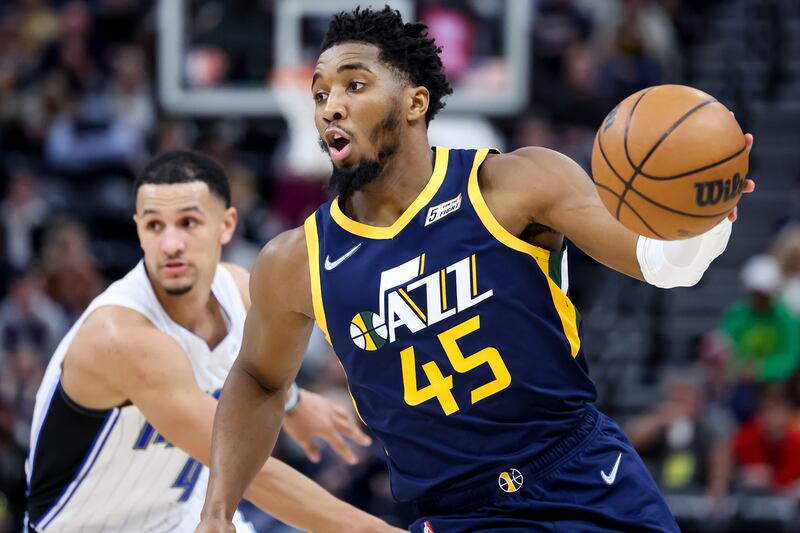 Utah Jazz guard Donovan Mitchell (45) drives ahead of Orlando Magic guard Jalen Suggs (4).