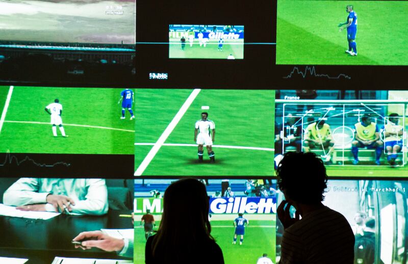 Visitors stand in front of the video installation 'Deep Play' by Harun Farockis in the exhibition 'The round and the square. Soccer in the art' on the occasion of the upcoming 2018 FIFA World Cup in Altenburg, Germany, Wednesday, June 13, 2018. The instal