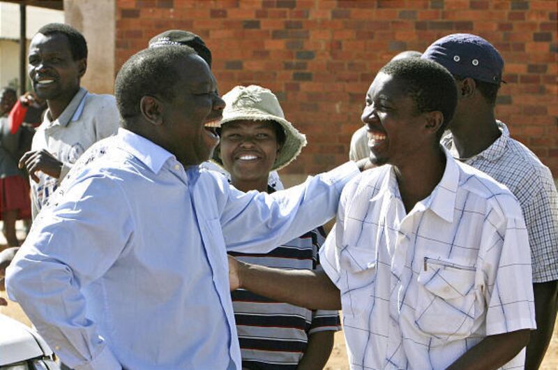 Opposition leader Morgan Tsvangirai talks to people on campaign trail in Esigodini, Zimbabwe, on Friday. While campaigning, he was stopped at roadblocks and taken in for police questioning.
