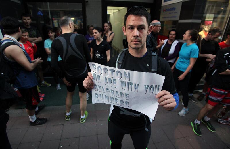 A runner shows a banner reading: "Boston we are with you - Belgrade runners" in an organized memorial run to show solidarity with victims of the Boston Marathon bombing, Tuesday, April 16, 2013, in Belgrade, Serbia. The explosions Monday afternoon killed